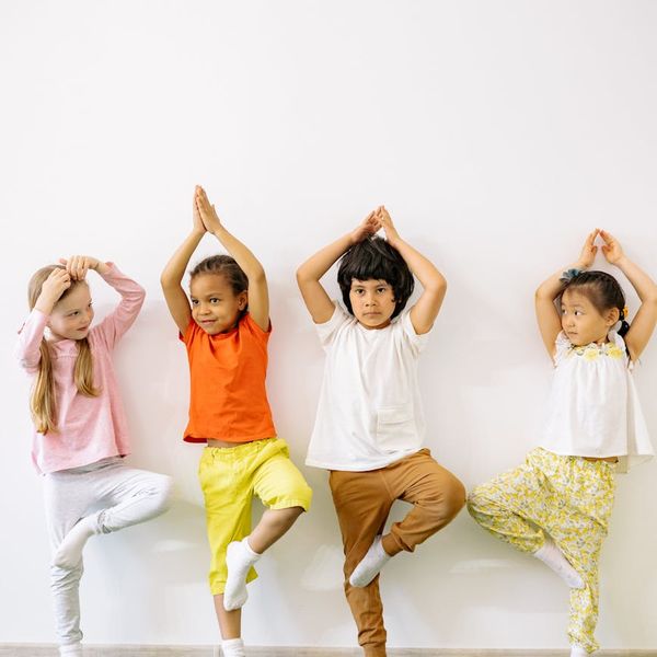 Group of kids playing and stretching in a bright, sunny room.